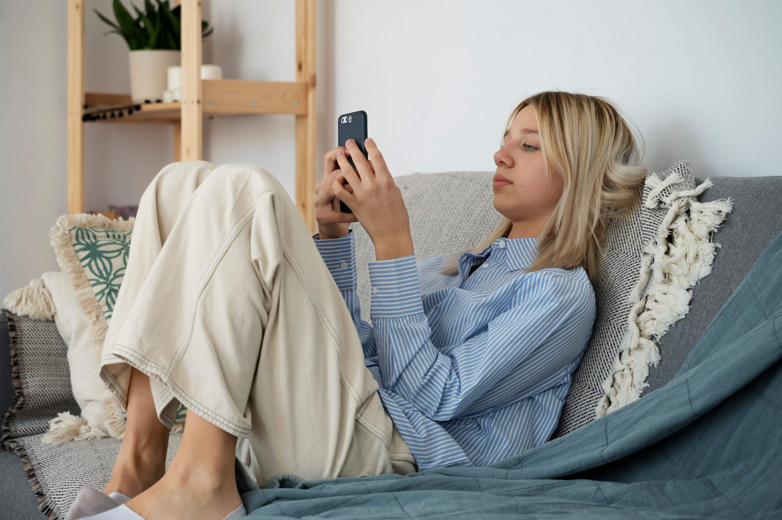 girl on the couch using a smartphone