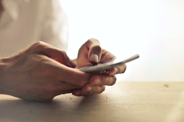 man's hand holding a smartphone