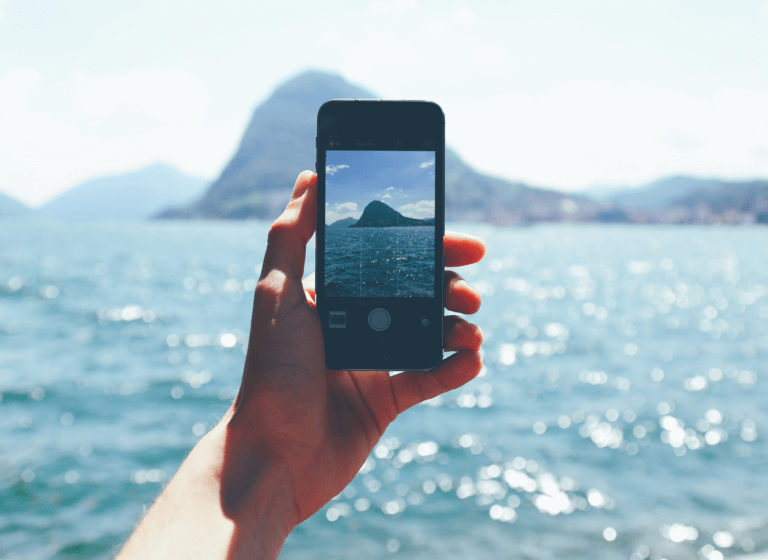 person taking picture of the sea